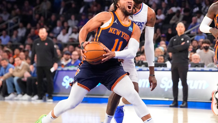 Nov 6, 2023; New York, New York, USA;  New York Knicks point guard Jalen Brunson (11) drives the ball towards the basket against Los Angeles Clipper forward Paul George (13) during the first quarter at Madison Square Garden. Mandatory Credit: Gregory Fisher-USA TODAY Sports