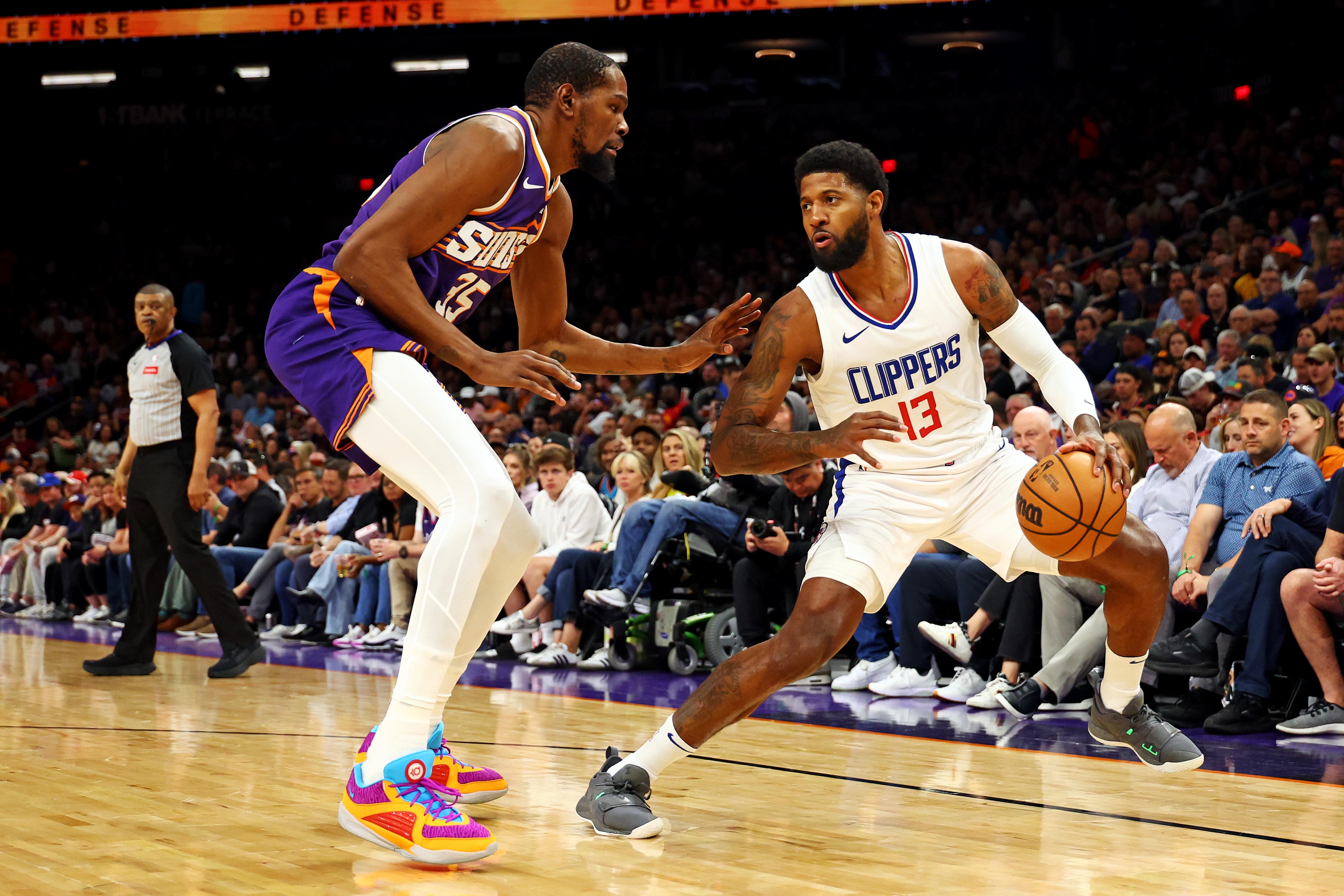 Apr 9, 2024; Phoenix, Arizona, USA;  (New York Knicks) LA Clippers forward Paul George (13) handles the ball against Phoenix Suns forward Kevin Durant (35) during the first quarter at Footprint Center. Mandatory Credit: Mark J. Rebilas-USA TODAY Sports