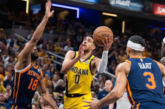 May 12, 2024; Indianapolis, Indiana, USA;  Indiana Pacers guard Tyrese Haliburton (0) shoots the ball while New York Knicks guard Alec Burks (18) defends during game four of the second round for the 2024 NBA playoffs at Gainbridge Fieldhouse. Mandatory Credit: Trevor Ruszkowski-USA TODAY Sports