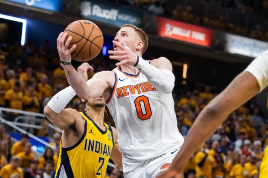 May 17, 2024; Indianapolis, Indiana, USA; New York Knicks guard Donte DiVincenzo (0) shoots the ball while Indiana Pacers guard Andrew Nembhard (2) defends during game six of the second round for the 2024 NBA playoffs at Gainbridge Fieldhouse. Mandatory Credit: Trevor Ruszkowski-USA TODAY Sports