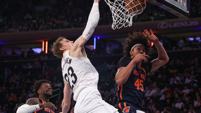 Feb 11, 2023; New York, New York, USA; Utah Jazz forward Lauri Markkanen (23) dunks the ball against New York Knicks center Jericho Sims (45) and forward Julius Randle (30) during the second half at Madison Square Garden. Mandatory Credit: Vincent Carchietta-USA TODAY Sports