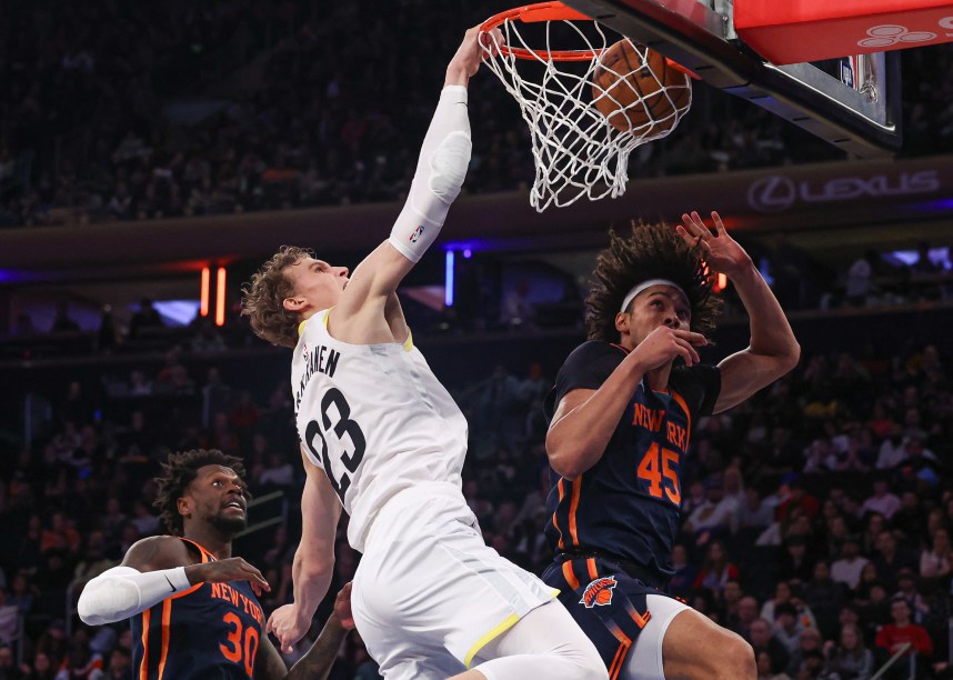 Feb 11, 2023; New York, New York, USA; Utah Jazz forward Lauri Markkanen (23) dunks the ball against New York Knicks center Jericho Sims (45) and forward Julius Randle (30) during the second half at Madison Square Garden. Mandatory Credit: Vincent Carchietta-USA TODAY Sports