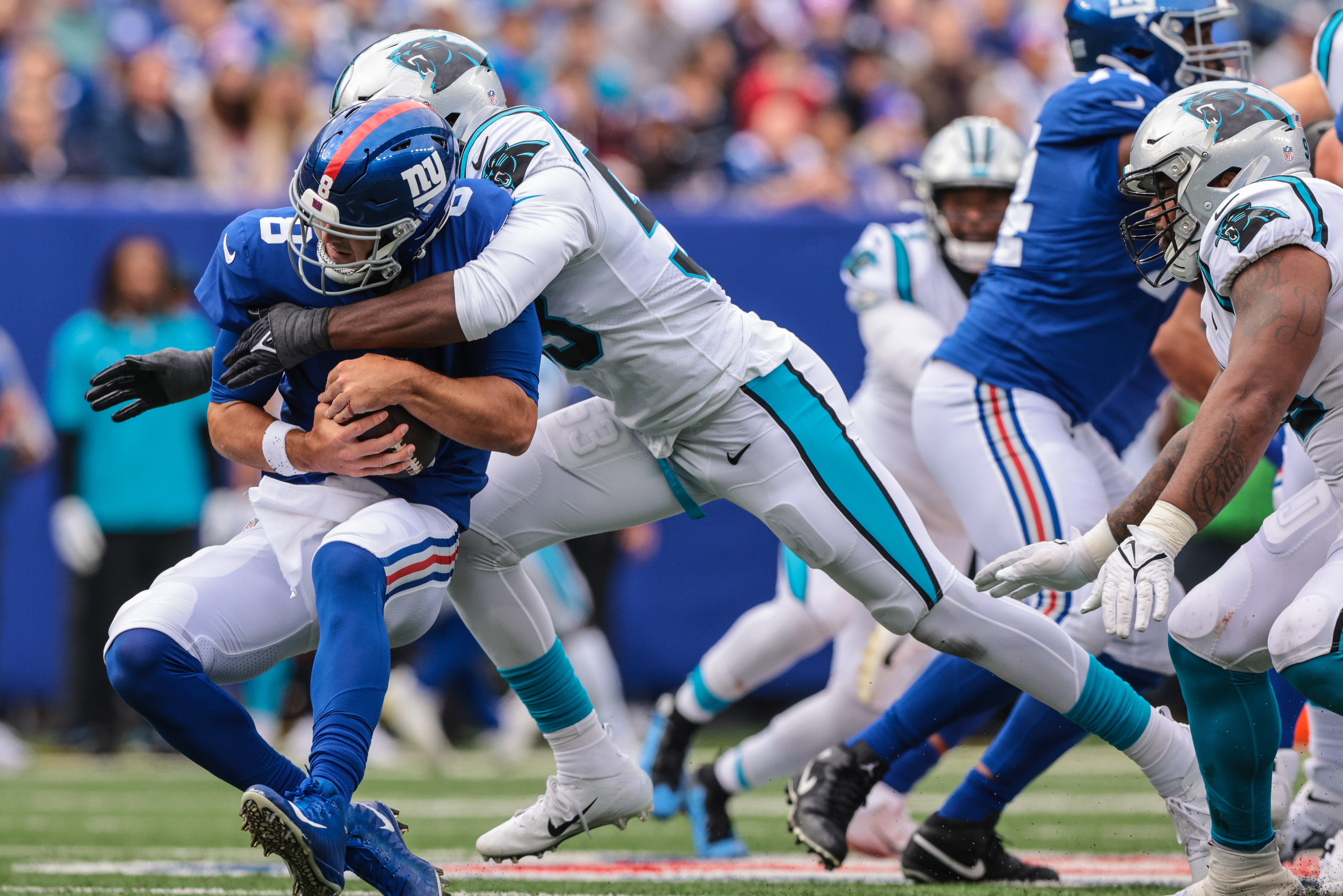 Oct 24, 2021; East Rutherford, New Jersey, USA; New York Giants quarterback Daniel Jones (8) is sacked by Carolina Panthers defensive end Brian Burns (53) during the first half at MetLife Stadium. Mandatory Credit: Vincent Carchietta-USA TODAY Sports