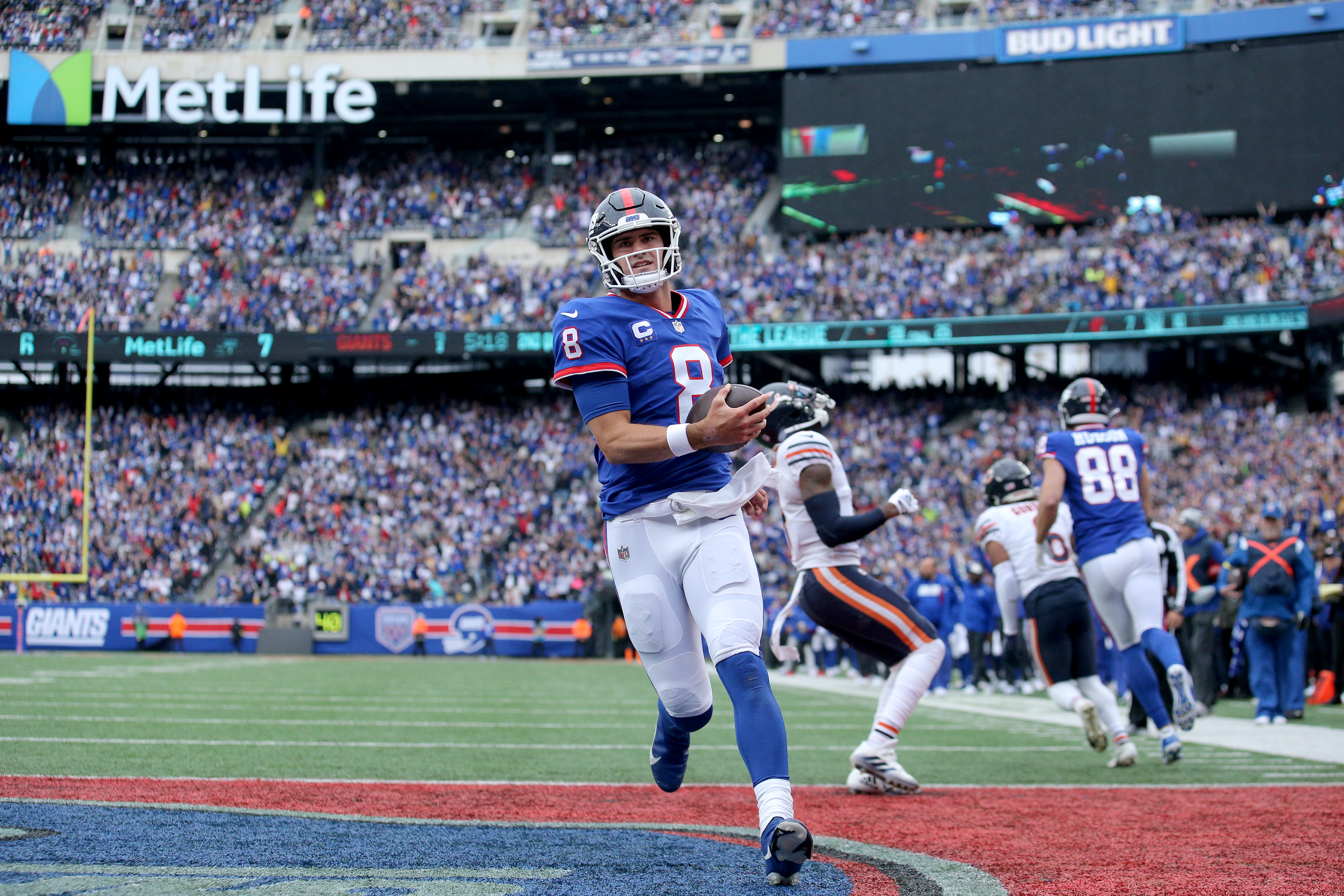 Oct 2, 2022; East Rutherford, New Jersey, USA; New York Giants quarterback Daniel Jones (8) runs for a touchdown against the Chicago Bears during the second quarter at MetLife Stadium. Mandatory Credit: Brad Penner-USA TODAY Sports