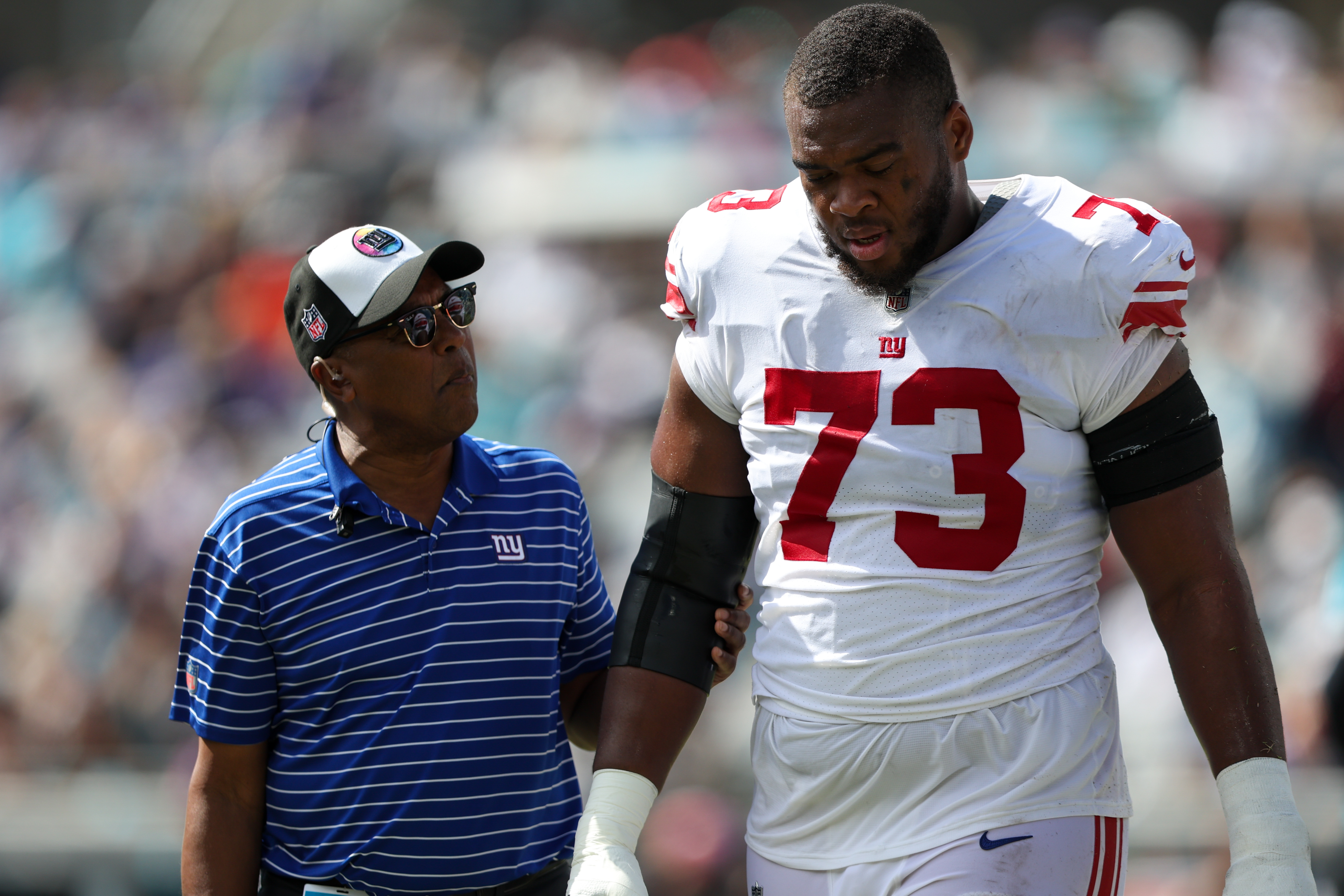 Oct 23, 2022; Jacksonville, Florida, USA;  New York Giants offensive tackle Evan Neal (73) leaves the field with an injury against the Jacksonville Jaguars in the second quarter at TIAA Bank Field. Mandatory Credit: Nathan Ray Seebeck-USA TODAY Sports