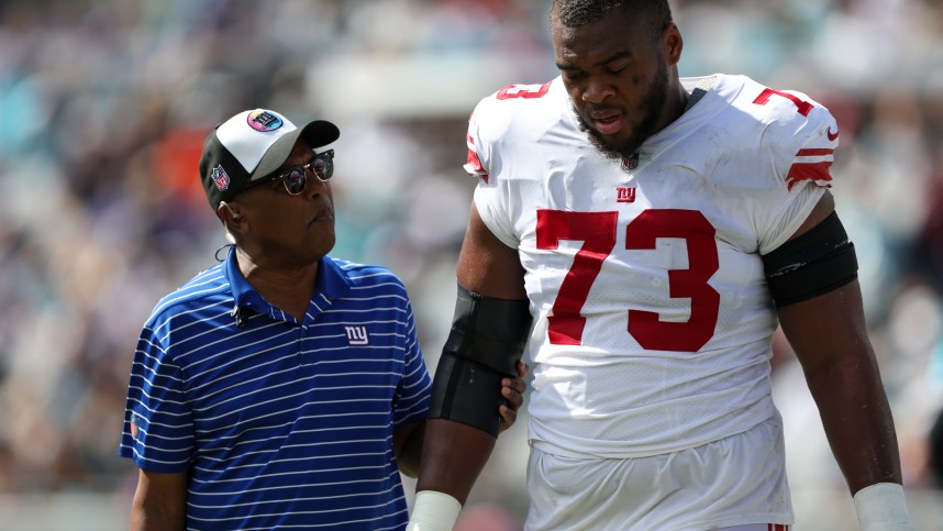 Oct 23, 2022; Jacksonville, Florida, USA;  New York Giants offensive tackle Evan Neal (73) leaves the field with an injury against the Jacksonville Jaguars in the second quarter at TIAA Bank Field. Mandatory Credit: Nathan Ray Seebeck-USA TODAY Sports