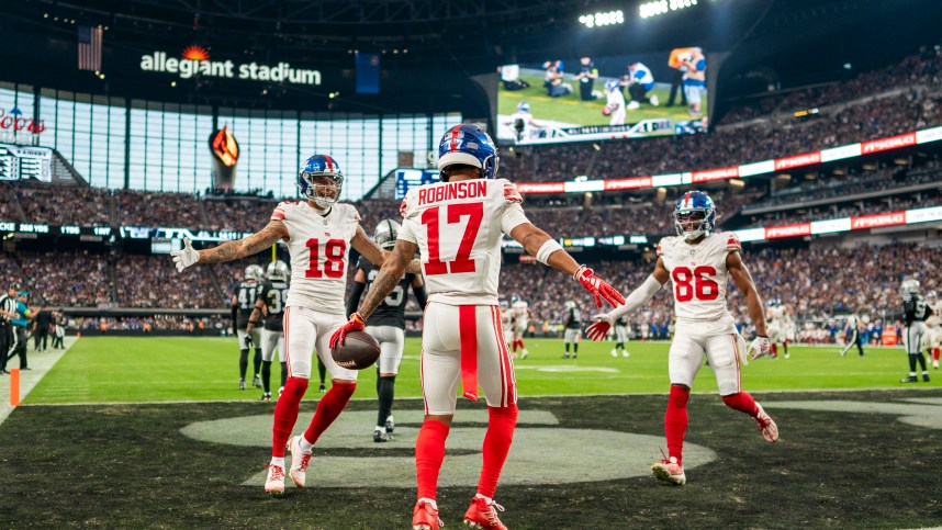 November 5, 2023; Paradise, Nevada, USA; New York Giants wide receiver Wan'Dale Robinson (17) is congratulated by wide receiver Isaiah Hodgins (18) and wide receiver Darius Slayton (86) for scoring a touchdown against the Las Vegas Raiders during the fourth quarter at Allegiant Stadium. Mandatory Credit: Kyle Terada-USA TODAY Sports
