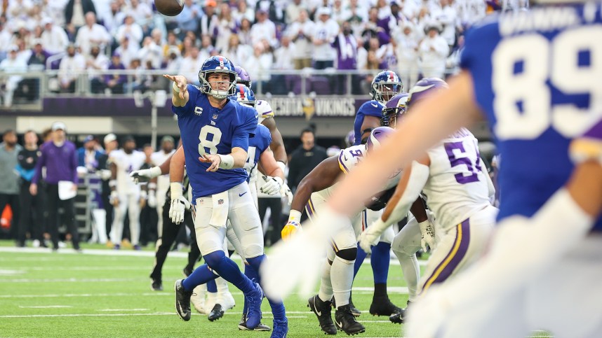 Dec 24, 2022; Minneapolis, Minnesota, USA; New York Giants quarterback Daniel Jones (8) throws a touchdown pass during the second quarter against the Minnesota Vikings at U.S. Bank Stadium. Mandatory Credit: Matt Krohn-USA TODAY Sports