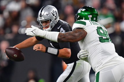 Nov 12, 2023; Paradise, Nevada, USA; Las Vegas Raiders quarterback Aidan O'Connell (4) comes under pressure from New York Jets defensive end John Franklin-Myers (91) during the first half at Allegiant Stadium. Mandatory Credit: Gary A. Vasquez-USA TODAY Sports