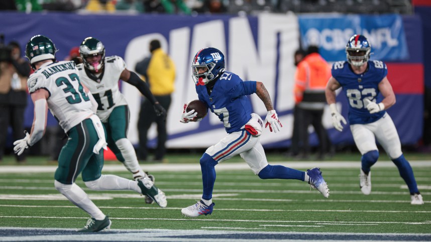 Jan 7, 2024; East Rutherford, New Jersey, USA; New York Giants wide receiver Wan'Dale Robinson (17) gains yards after catch asPhiladelphia Eagles safety Reed Blankenship (32) pursues during the first quarter at MetLife Stadium. Mandatory Credit: Vincent Carchietta-USA TODAY Sports