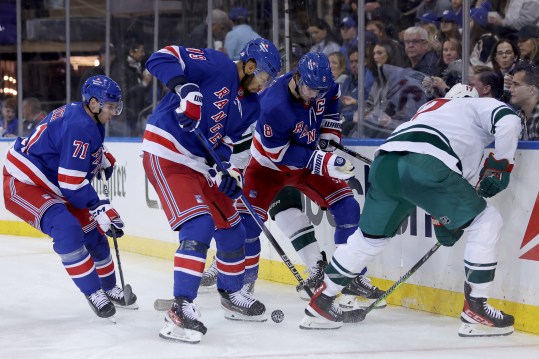 Nov 9, 2023; New York, New York, USA; Minnesota Wild left wing Marcus Foligno (17) fights for the puck against New York Rangers defensemen Jacob Trouba (8) and K'Andre Miller (79) and center Tyler Pitlick (71) during the third period at Madison Square Garden. Mandatory Credit: Brad Penner-USA TODAY Sports