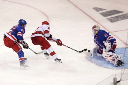 May 7, 2024; New York, New York, USA; Carolina Hurricanes center Sebastian Aho (20) takes a shot against New York Rangers goaltender Igor Shesterkin (31) in front of Rangers defenseman Ryan Lindgren (55) during the first overtime of game two of the second round of the 2024 Stanley Cup Playoffs at Madison Square Garden. Mandatory Credit: Brad Penner-USA TODAY Sports