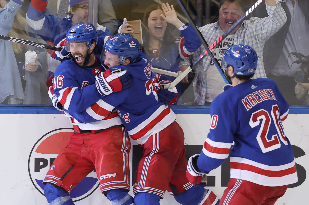 May 7, 2024; New York, New York, USA; New York Rangers center Vincent Trocheck (16) celebrates his game winning goal against the Carolina Hurricanes with defenseman Adam Fox (23) and left wing Chris Kreider (20) during the second overtime of game two of the second round of the 2024 Stanley Cup Playoffs at Madison Square Garden. Mandatory Credit: Brad Penner-USA TODAY Sports