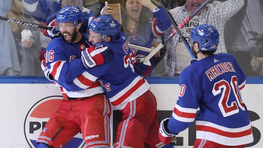 May 7, 2024; New York, New York, USA; New York Rangers center Vincent Trocheck (16) celebrates his game winning goal against the Carolina Hurricanes with defenseman Adam Fox (23) and left wing Chris Kreider (20) during the second overtime of game two of the second round of the 2024 Stanley Cup Playoffs at Madison Square Garden. Mandatory Credit: Brad Penner-USA TODAY Sports