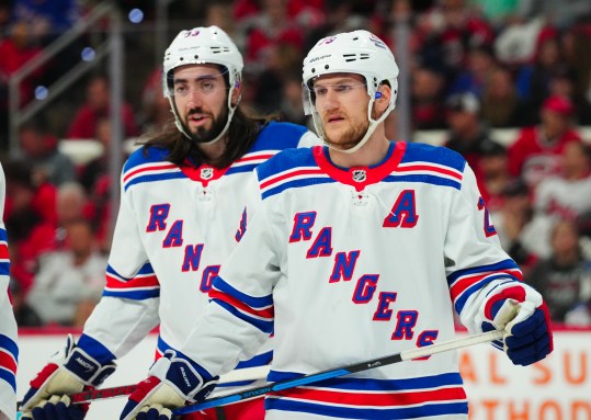 May 11, 2024; Raleigh, North Carolina, USA; New York Rangers defenseman Adam Fox (23) and center Mika Zibanejad (93) look on against the Carolina Hurricanes during the first period in game four of the second round of the 2024 Stanley Cup Playoffs at PNC Arena. Mandatory Credit: James Guillory-USA TODAY Sports