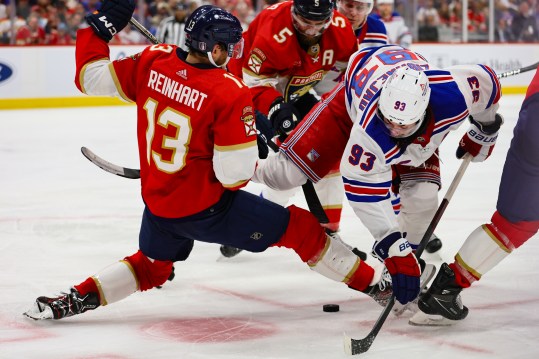 May 28, 2024; Sunrise, Florida, USA; New York Rangers center Mika Zibanejad (93) and Florida Panthers center Sam Reinhart (13) battle for the puck during the third period in game four of the Eastern Conference Final of the 2024 Stanley Cup Playoffs at Amerant Bank Arena. Mandatory Credit: Sam Navarro-USA TODAY Sports