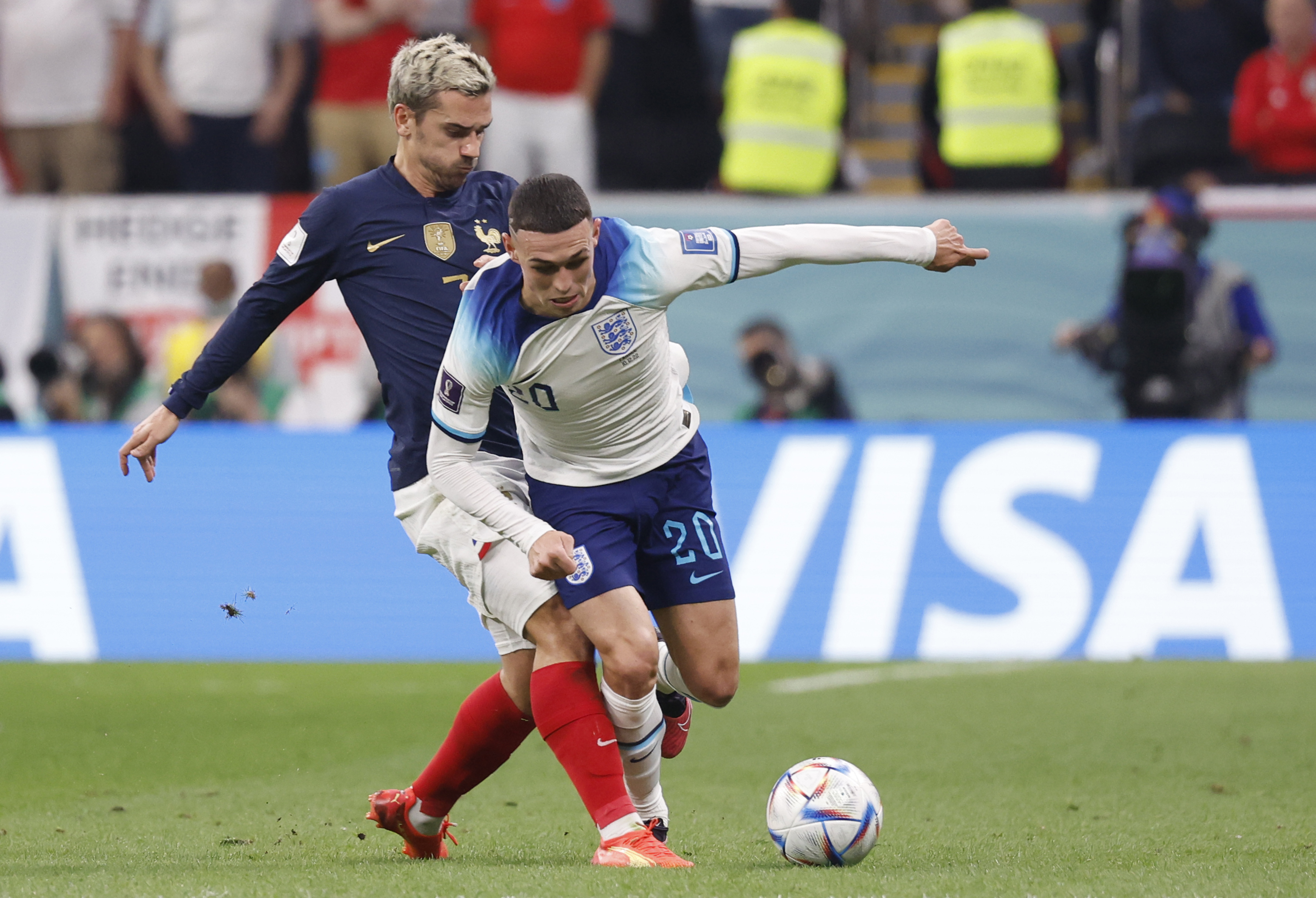 Dec 10, 2022; Al Khor, Qatar; England midfielder Phil Foden (Manchester City) (20) and France forward Antoine Griezmann (7) battle for the ball during the first half of a quarterfinal game in the 2022 FIFA World Cup at Al-Bayt Stadium. Mandatory Credit: Yukihito Taguchi-USA TODAY Sports