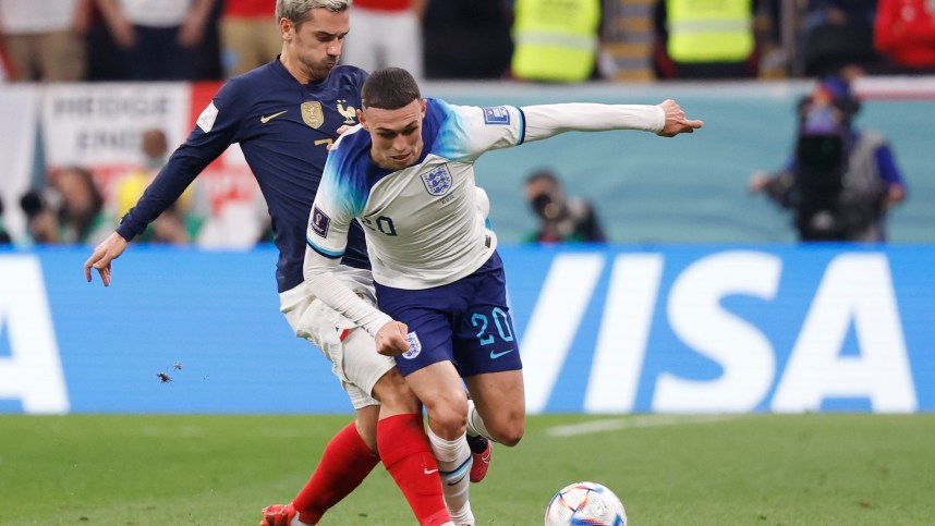 Dec 10, 2022; Al Khor, Qatar; England midfielder Phil Foden (Manchester City) (20) and France forward Antoine Griezmann (7) battle for the ball during the first half of a quarterfinal game in the 2022 FIFA World Cup at Al-Bayt Stadium. Mandatory Credit: Yukihito Taguchi-USA TODAY Sports