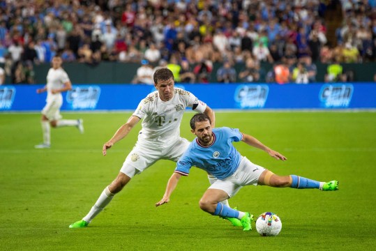 July 23, 2022; Green Bay, WI, USA; FC Bayern Munich forward Thomas M  ller (25) and Manchester City midfielder Bernardo Silva (20) fight for the ball during the exhibition match on Saturday, July 23, 2022 at Lambeau Field in Green Bay, Wis. Mandatory Credit: Samantha Madar-USA TODAY Sports