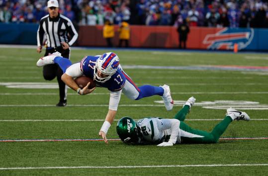 Buffalo Bills quarterback Josh Allen (17) is tackled by New York Jets running back Israel Abanikanda (25) after a short gain. Credit:Jamie Germano/Rochester Democrat and Chronicle / USA TODAY NETWORK