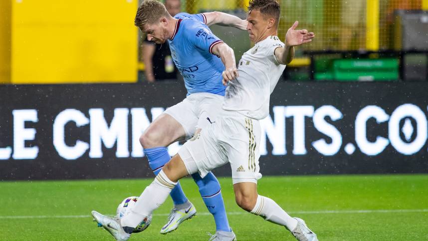 Manchester City midfielder Kevin De Bruyne (17) and FC Bayern Munich midfielder Joshua Kimmich (6) fight for the ball during the exhibition match on Saturday, July 23, 2022, at Lambeau Field in Green Bay, Wis.