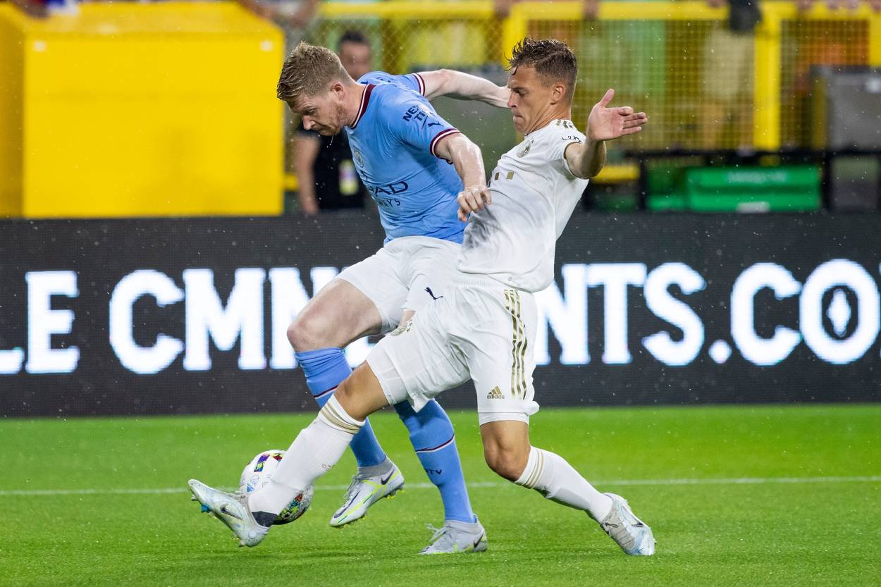 Manchester City midfielder Kevin De Bruyne (17) and FC Bayern Munich midfielder Joshua Kimmich (6) fight for the ball during the exhibition match on Saturday, July 23, 2022, at Lambeau Field in Green Bay, Wis.