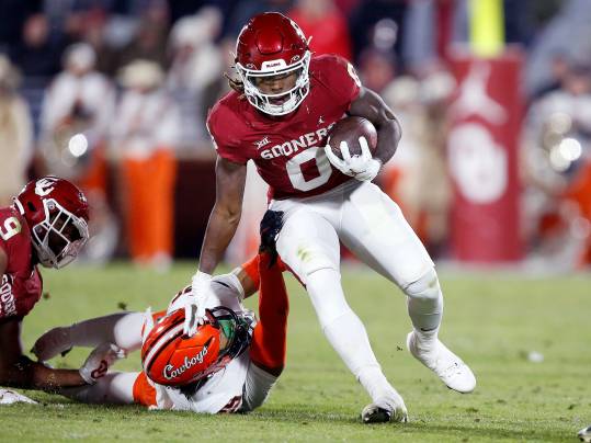 Oklahoma's Eric Gray (0) gets by Oklahoma State's Jason Taylor II (25) in the first half during the Bedlam college football game between the University of Oklahoma Sooners (OU) and the Oklahoma State University Cowboys (OSU) at Gaylord Family-Oklahoma Memorial Stadium, in Norman, Okla., Saturday, Nov., 19, 2022.  Credit:SARAH PHIPPS/THE OKLAHOMAN / USA TODAY NETWORK
