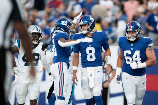 Aug 18, 2023; East Rutherford, NJ, USA; The Carolina Panthers vs. the New York Giants in an NFL preseason game at MetLife Stadium. New York Giants quarterback Daniel Jones (8) celebrates after throwing a pass for a touchdown in the first quarter. Mandatory Credit: Michael Karas-The Record