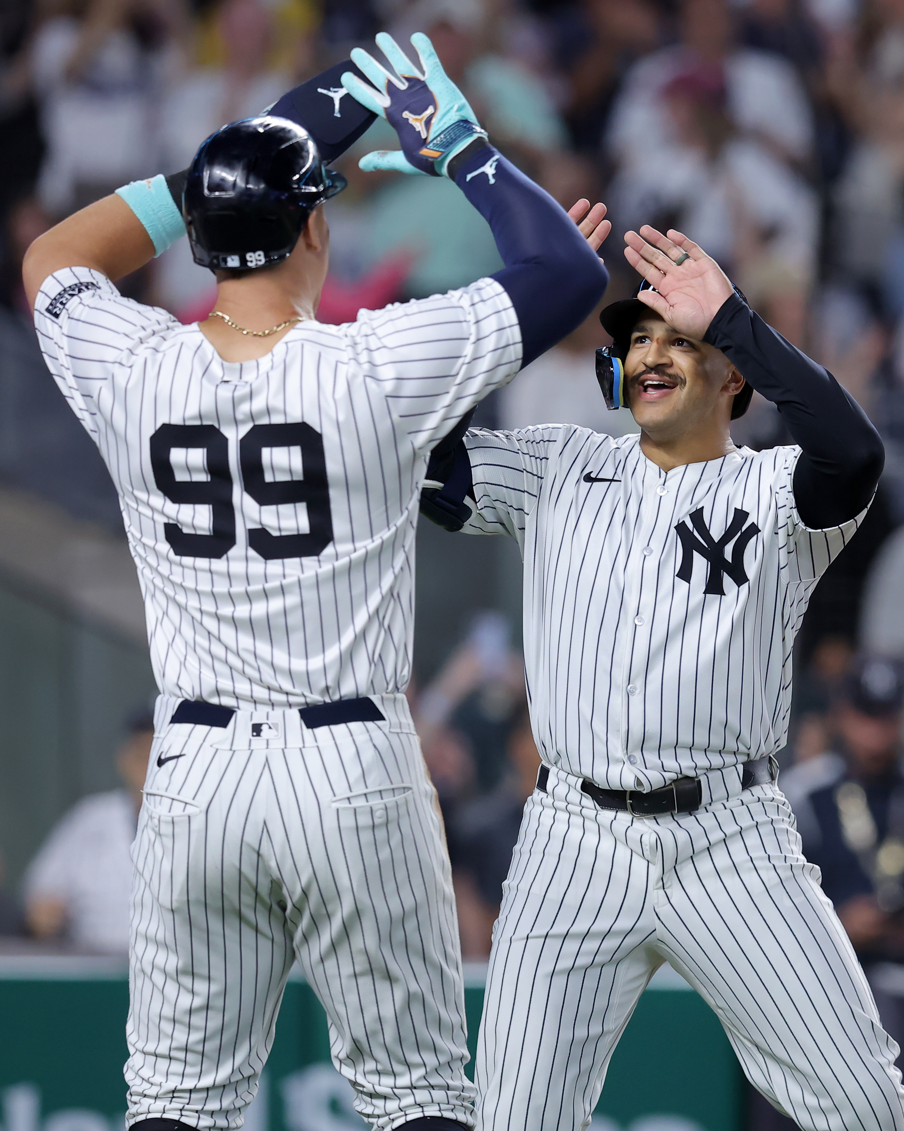 Jun 9, 2024; Bronx, New York, USA; New York Yankees center fielder Trent Grisham (12) celebrates his three run home run against the Los Angeles Dodgers with right fielder Aaron Judge (99) during the sixth inning at Yankee Stadium. Mandatory Credit: Brad Penner-USA TODAY Sports