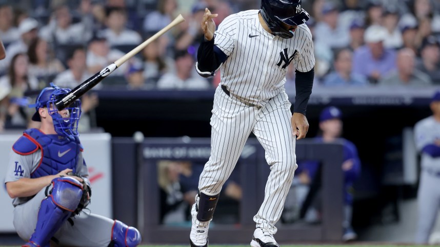 Jun 9, 2024; Bronx, New York, USA; New York Yankees center fielder Trent Grisham (12) tosses his bat after hitting a three run home run against the Los Angeles Dodgers during the sixth inning at Yankee Stadium. Mandatory Credit: Brad Penner-USA TODAY Sports