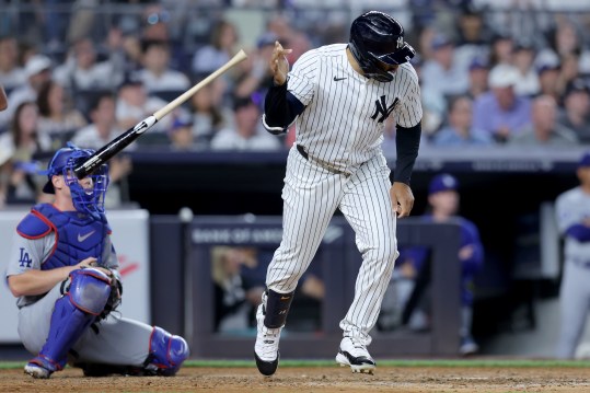 Jun 9, 2024; Bronx, New York, USA; New York Yankees center fielder Trent Grisham (12) tosses his bat after hitting a three run home run against the Los Angeles Dodgers during the sixth inning at Yankee Stadium. Mandatory Credit: Brad Penner-USA TODAY Sports