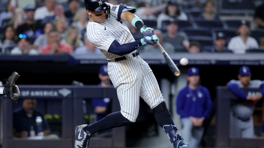 Jun 9, 2024; Bronx, New York, USA; New York Yankees right fielder Aaron Judge (99) hits a solo home run against the Los Angeles Dodgers during the eighth inning at Yankee Stadium. Mandatory Credit: Brad Penner-USA TODAY Sports