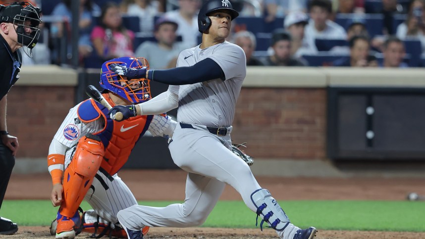 Jun 25, 2024; New York City, New York, USA; New York Yankees right fielder Juan Soto (22) follows through on a solo home run against the New York Mets during the fifth inning at Citi Field. Mandatory Credit: Brad Penner-USA TODAY Sports