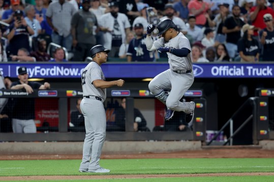 Jun 25, 2024; New York City, New York, USA; New York Yankees right fielder Juan Soto (22) celebrates with third base coach Luis Rojas (67) as he rounds the bases after hitting a solo home run against the New York Mets during the fifth inning at Citi Field. Mandatory Credit: Brad Penner-USA TODAY Sports