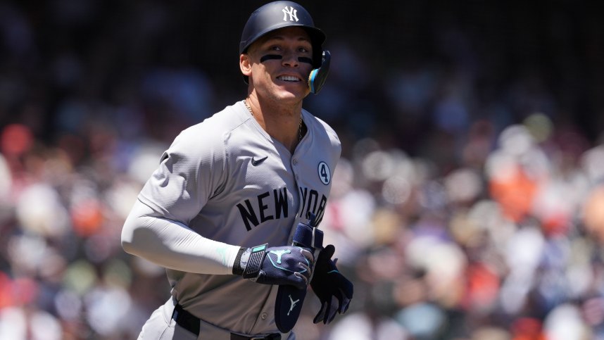 Jun 2, 2024; San Francisco, California, USA; New York Yankees center fielder Aaron Judge (99) jogs to first base after drawing a walk against the San Francisco Giants during the third inning at Oracle Park. Mandatory Credit: Darren Yamashita-USA TODAY Sports