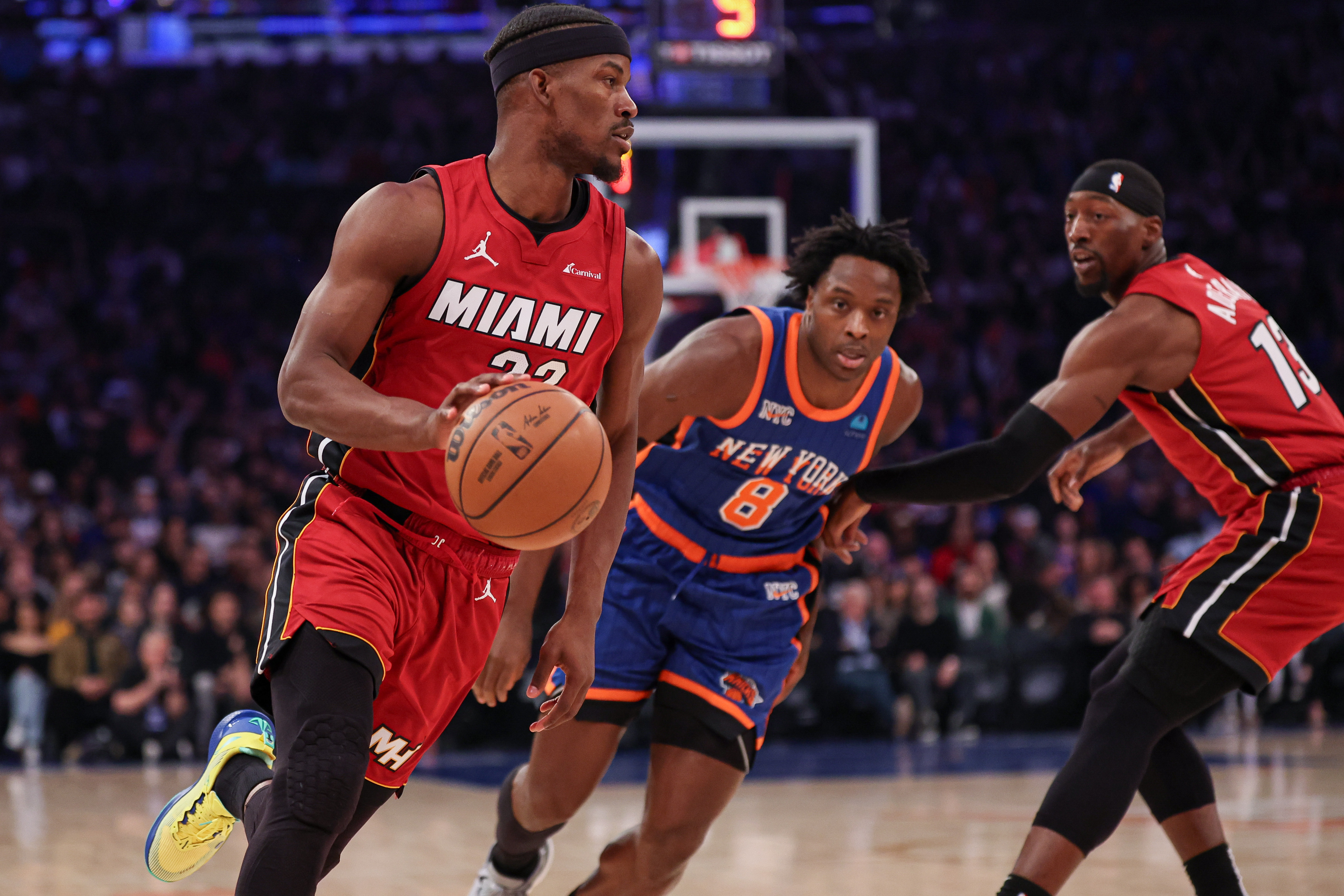 Jan 27, 2024; New York, New York, USA; Miami Heat forward Jimmy Butler (22) dribbles in front of New York Knicks forward OG Anunoby (8) and guard Evan Fournier (13) during the first half at Madison Square Garden. Mandatory Credit: Vincent Carchietta-USA TODAY Sports