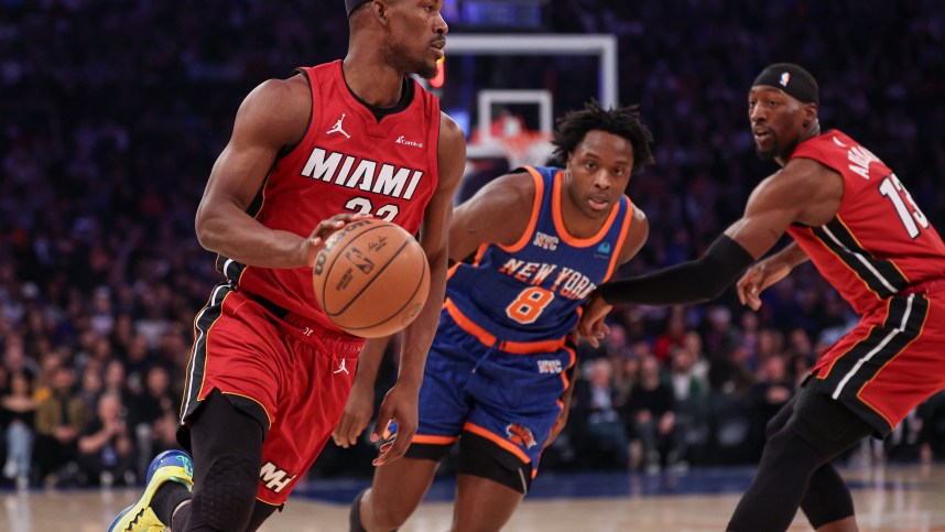 Jan 27, 2024; New York, New York, USA; Miami Heat forward Jimmy Butler (22) dribbles in front of New York Knicks forward OG Anunoby (8) and guard Evan Fournier (13) during the first half at Madison Square Garden. Mandatory Credit: Vincent Carchietta-USA TODAY Sports