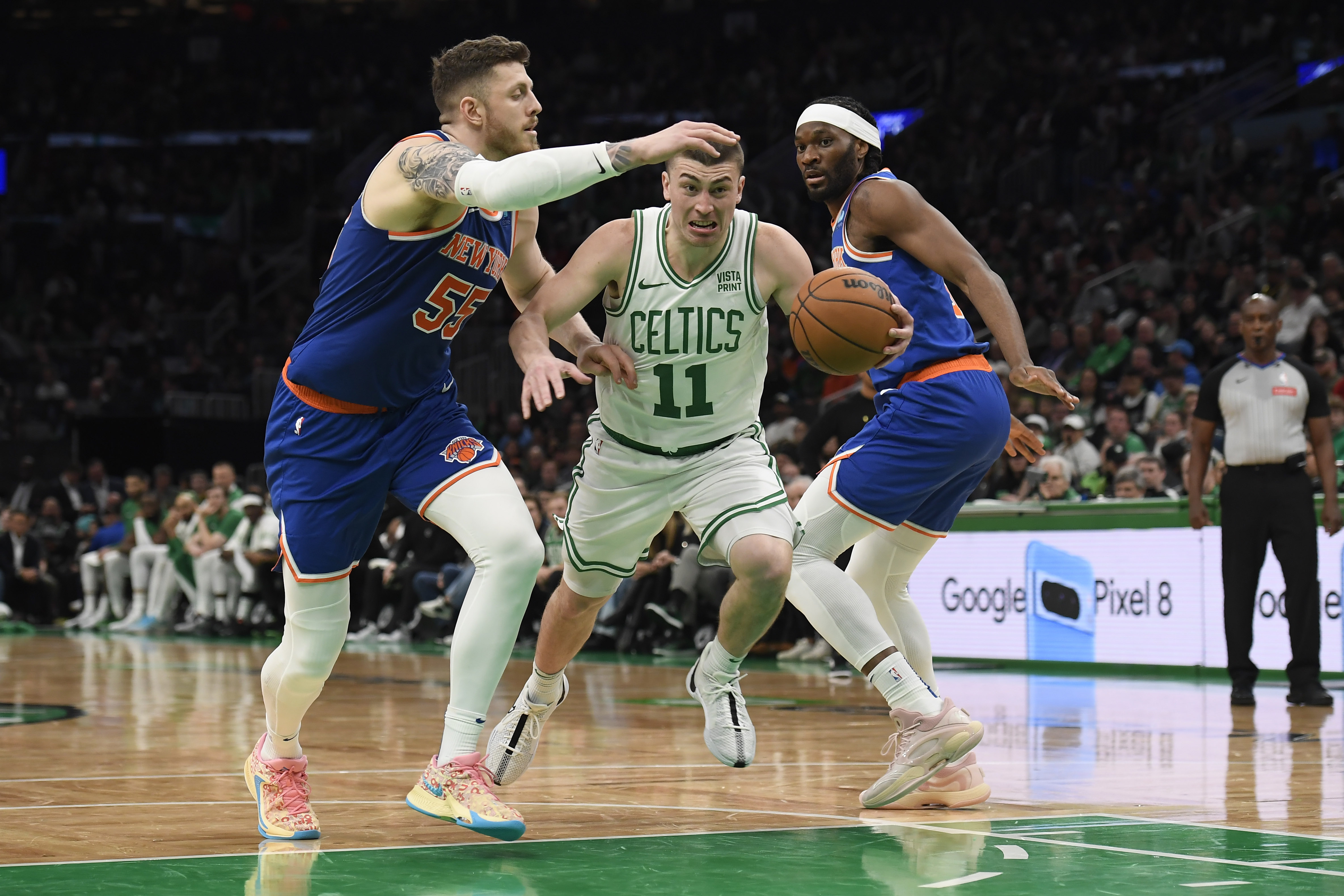 Apr 11, 2024; Boston, Massachusetts, USA;  Boston Celtics guard Payton Pritchard (11) controls the ball while New York Knicks center Isaiah Hartenstein (55) and forward Precious Achiuwa (5) defend during the second half at TD Garden. Mandatory Credit: Bob DeChiara-USA TODAY Sports