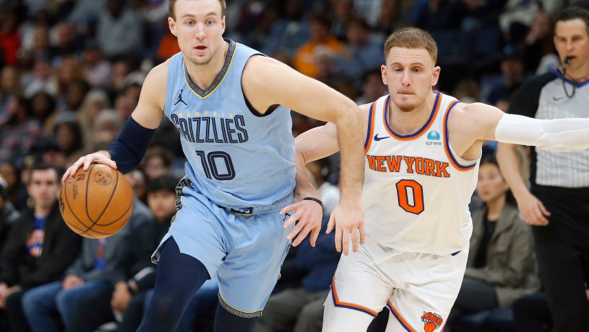 Jan 13, 2024; Memphis, Tennessee, USA; Memphis Grizzlies guard Luke Kennard (10) drives to the basket as New York Knicks guard Donte DiVincenzo (0) defends during the second half at FedExForum. Mandatory Credit: Petre Thomas-USA TODAY Sports