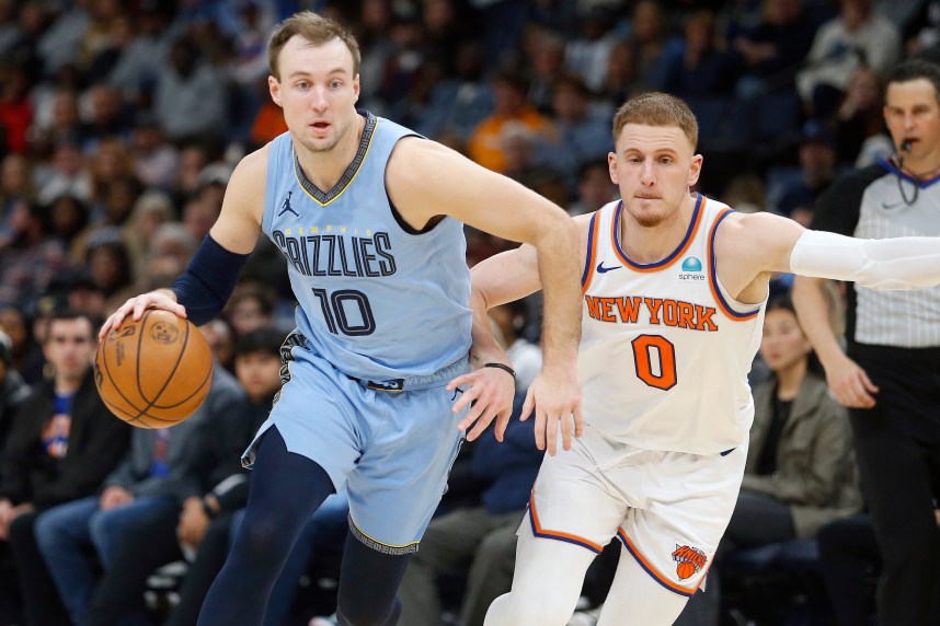 Jan 13, 2024; Memphis, Tennessee, USA; Memphis Grizzlies guard Luke Kennard (10) drives to the basket as New York Knicks guard Donte DiVincenzo (0) defends during the second half at FedExForum. Mandatory Credit: Petre Thomas-USA TODAY Sports