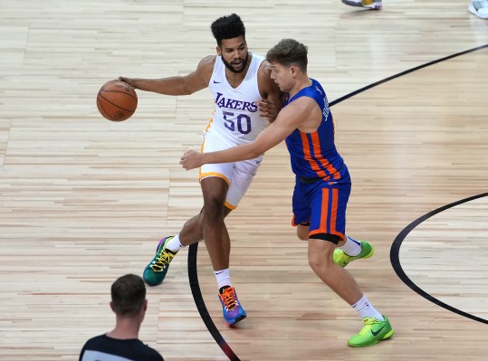 Aug 11, 2021; Las Vegas, Nevada, USA; Los Angeles Lakers forward Yoeli Childs (50) dribbles against New York Knicks guard Rokas Jokubaitis (0) during an NBA Summer League game at Thomas & Mack Center. Mandatory Credit: Stephen R. Sylvanie-USA TODAY Sports