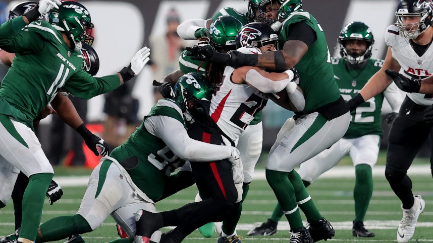 Dec 3, 2023; East Rutherford, New Jersey, USA; Atlanta Falcons running back Tyler Allgeier (25) is tackled by New York Jets defensive tackle Quinnen Williams (95) and linebacker C.J. Mosley (57) and defensive end John Franklin-Myers (91) and defensive tackle Quinton Jefferson (70) during the fourth quarter at MetLife Stadium. Mandatory Credit: Brad Penner-USA TODAY Sports