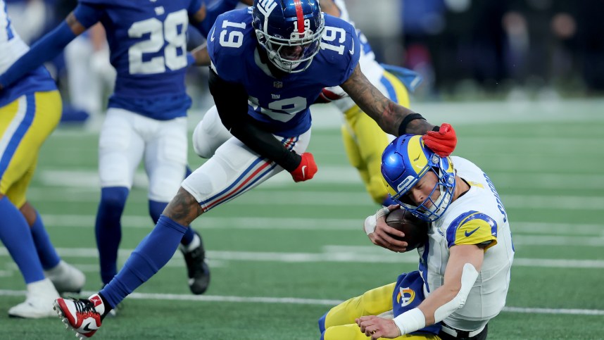 Dec 31, 2023; East Rutherford, New Jersey, USA; Los Angeles Rams quarterback Matthew Stafford (9) is sacked by New York Giants safety Isaiah Simmons (19) during the fourth quarter at MetLife Stadium. Mandatory Credit: Brad Penner-USA TODAY Sports