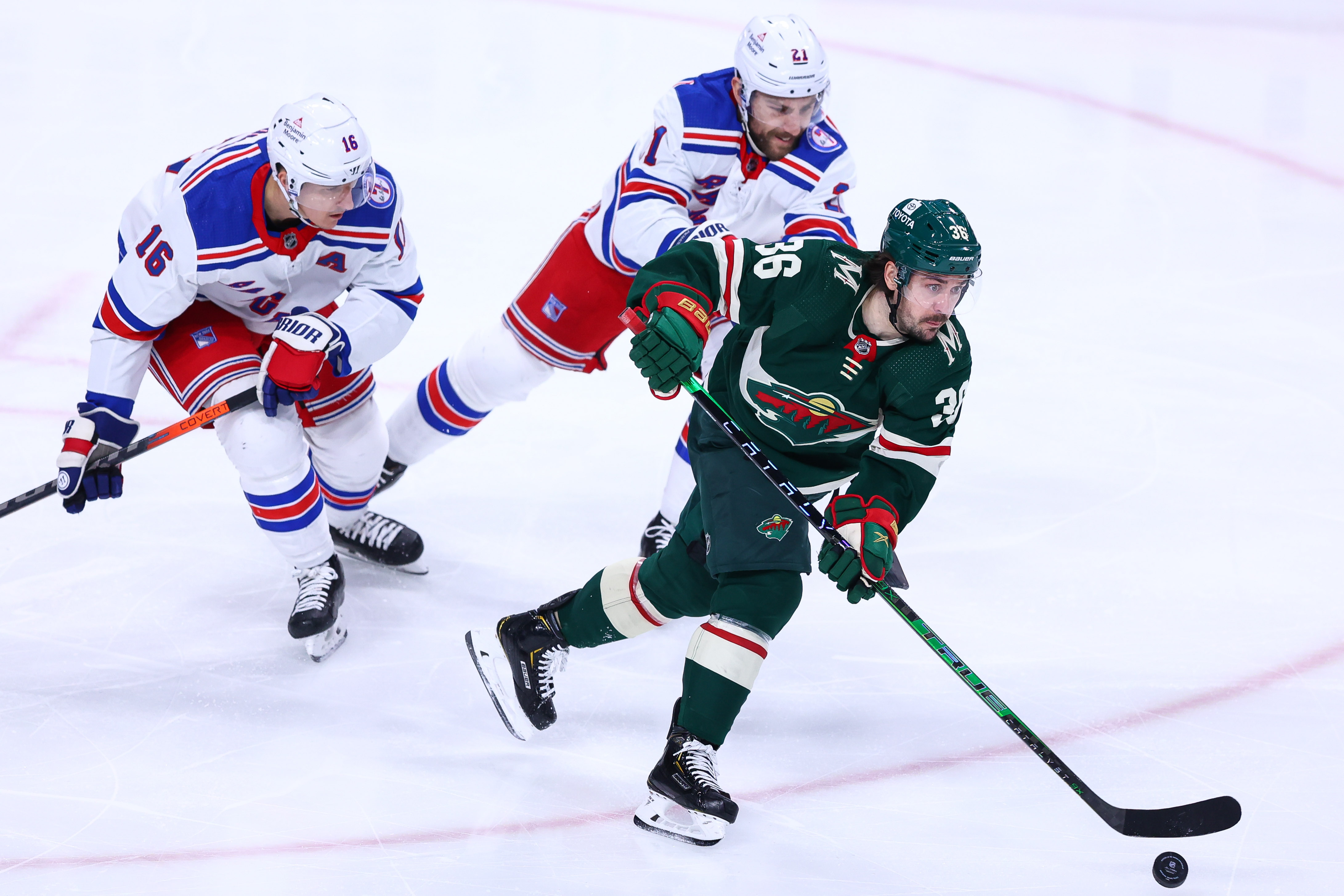 Mar 8, 2022; Saint Paul, Minnesota, USA; Minnesota Wild right wing Mats Zuccarello (36) skates with the puck as New York Rangers center Ryan Strome (16) and center Barclay Goodrow (21) defend during the third period at Xcel Energy Center. Mandatory Credit: Harrison Barden-USA TODAY Sports