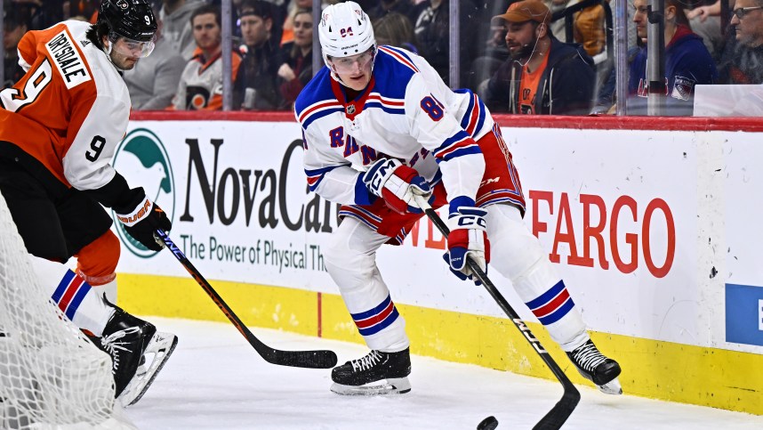 Feb 24, 2024; Philadelphia, Pennsylvania, USA; New York Rangers defenseman Jacob Trouba (8) reaches for the puck against New York Rangers center Adam Edstrom (84) in the second period at Wells Fargo Center. Mandatory Credit: Kyle Ross-USA TODAY Sports