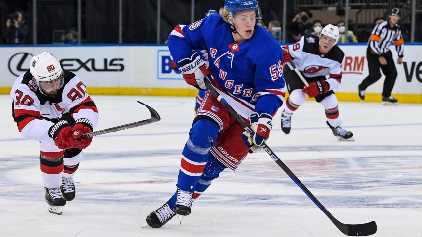 Sep 29, 2022; New York, New York, USA; New York Rangers center Karl Henriksson (59) skates with the puck against the New Jersey Devils during the third period at Madison Square Garden. Mandatory Credit: Dennis Schneidler-USA TODAY Sports