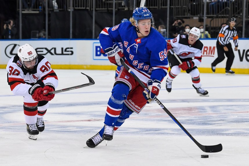Sep 29, 2022; New York, New York, USA; New York Rangers center Karl Henriksson (59) skates with the puck against the New Jersey Devils during the third period at Madison Square Garden. Mandatory Credit: Dennis Schneidler-USA TODAY Sports