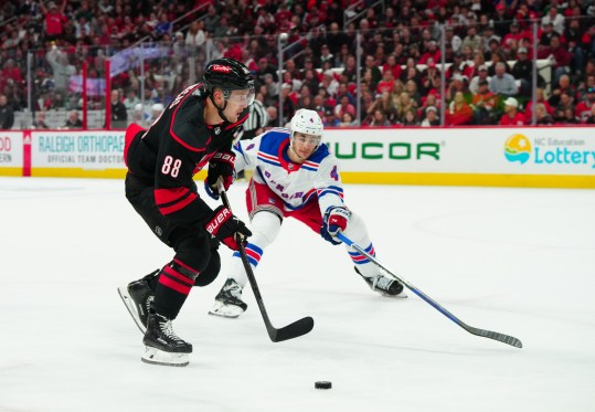 May 9, 2024; Raleigh, North Carolina, USA; Carolina Hurricanes center Martin Necas (88) skates with the puck past New York Rangers defenseman Braden Schneider (4) during the first period in game three of the second round of the 2024 Stanley Cup Playoffs at PNC Arena. Mandatory Credit: James Guillory-USA TODAY Sports