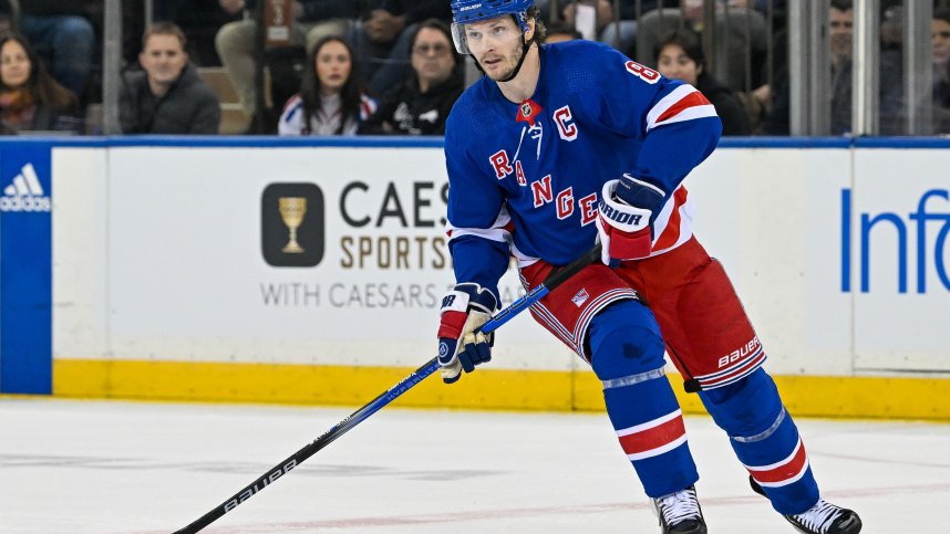 Apr 23, 2024; New York, New York, USA;  New York Rangers defenseman Jacob Trouba (8) skates with the puck against the Washington Capitals during the first period in game two of the first round of the 2024 Stanley Cup Playoffs at Madison Square Garden. Mandatory Credit: Dennis Schneidler-USA TODAY Sports