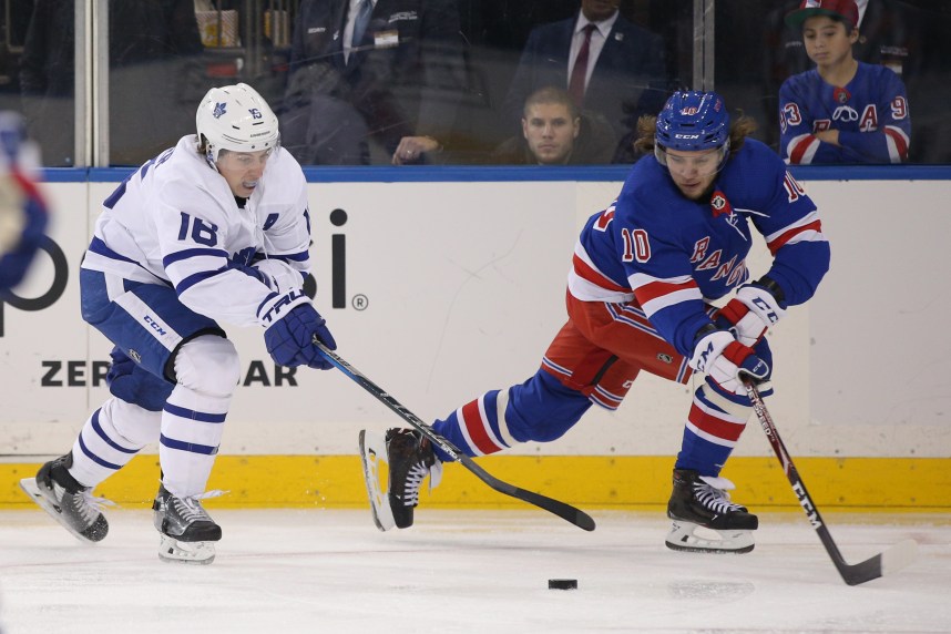 Dec 20, 2019; New York, NY, USA; Toronto Maple Leafs center Mitch Marner (16) steals the puck away from New York Rangers left wing Artemi Panarin (10) during the third period at Madison Square Garden. Mandatory Credit: Brad Penner-USA TODAY Sports
